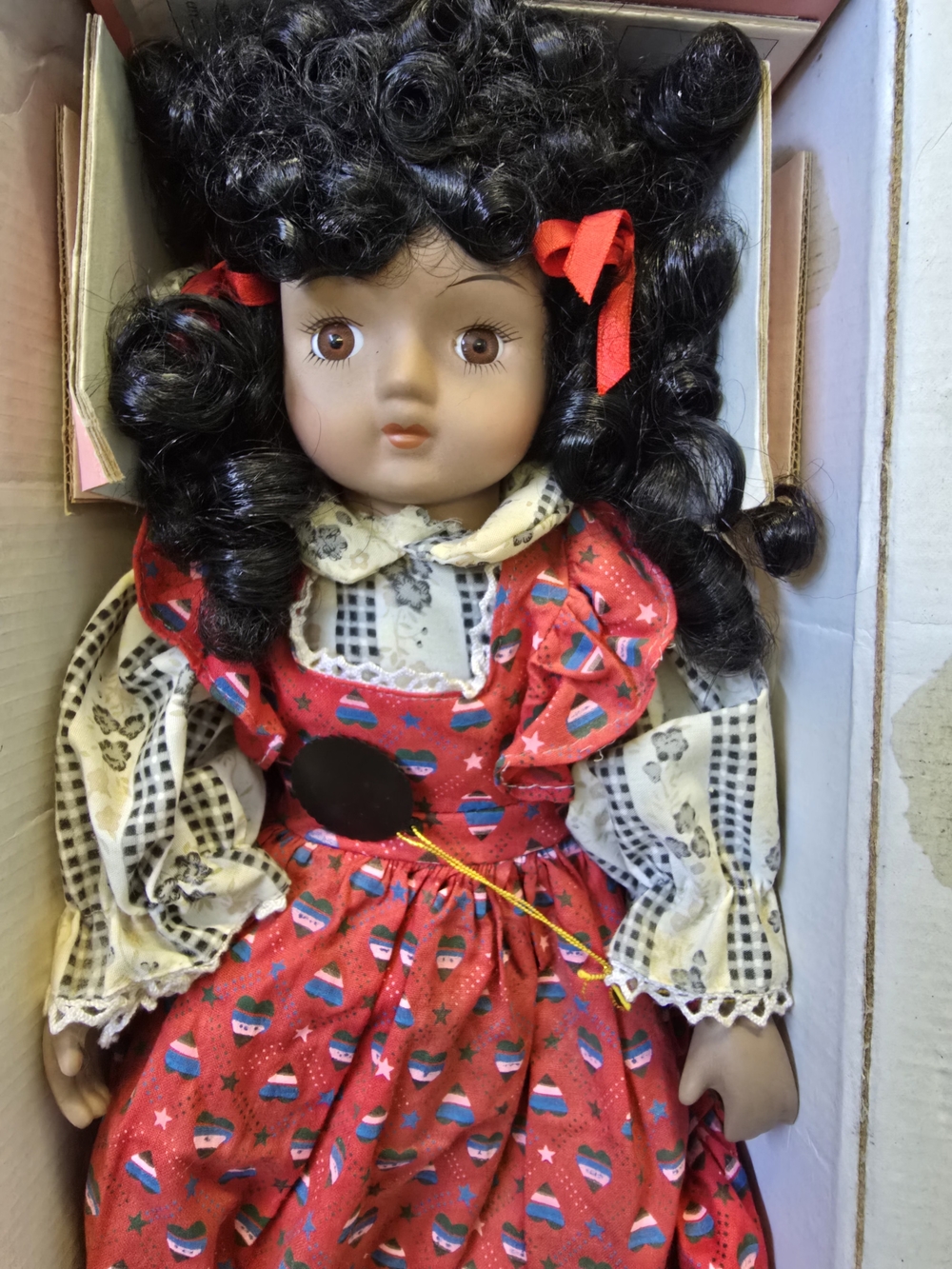 Source Unknown Red Dress Doll with Black Curly Hair and Red Ribbons